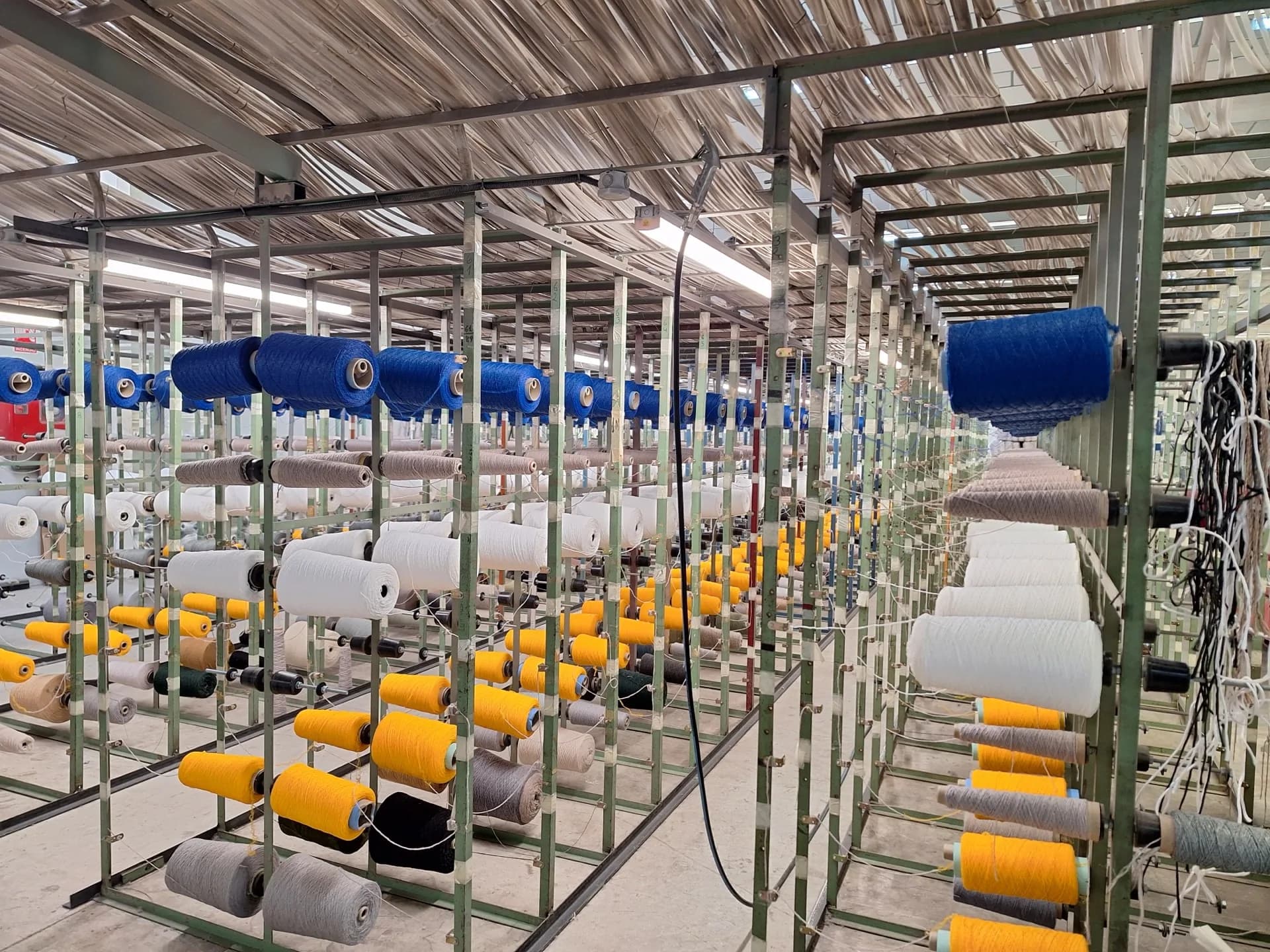 Colourful yarn cones at the Rols factory where Heroturfs turf is woven