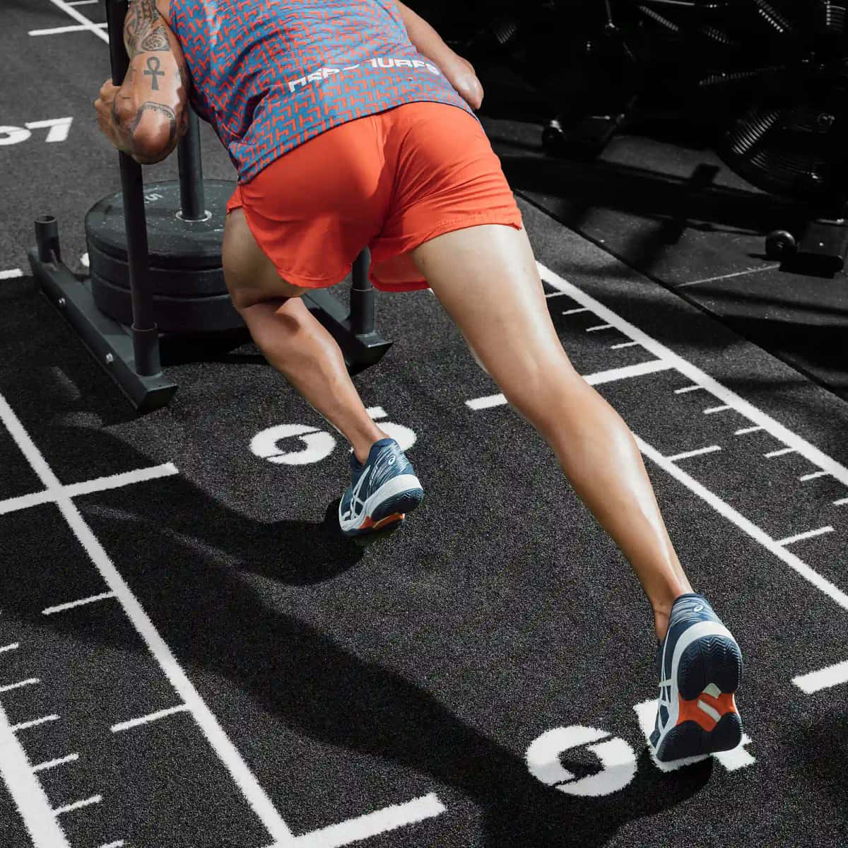 Sled drags and sled push on artificial turf for gyms